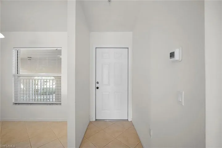 Foyer entrance featuring light tile patterned floors