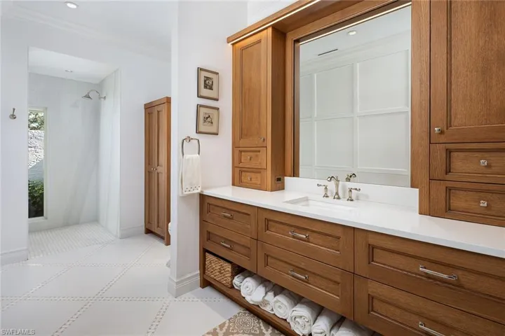 Full bath featuring curtained shower, vanity, ornamental molding, and recessed lighting