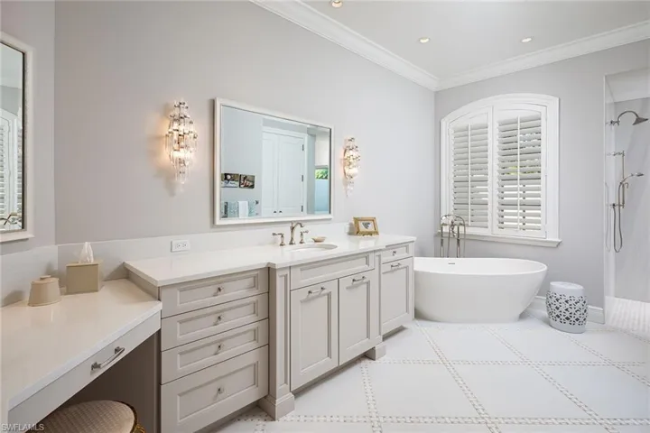 Bathroom featuring vanity, a freestanding bath, ornamental molding, a shower, and recessed lighting