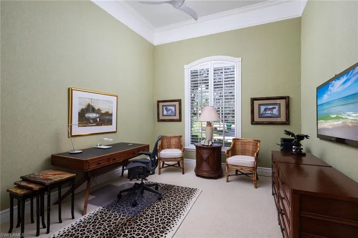 Home office with light carpet and ornamental molding