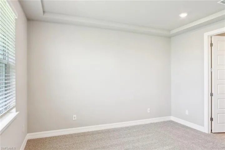 Empty room with carpet flooring, baseboards, and recessed lighting