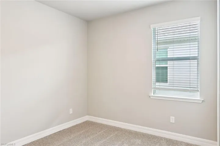 Empty room featuring carpet floors and baseboards