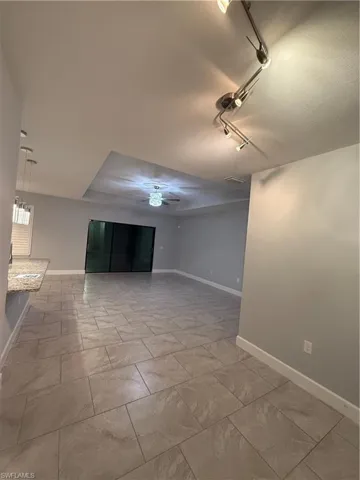 Empty room with ceiling fan and track lighting
