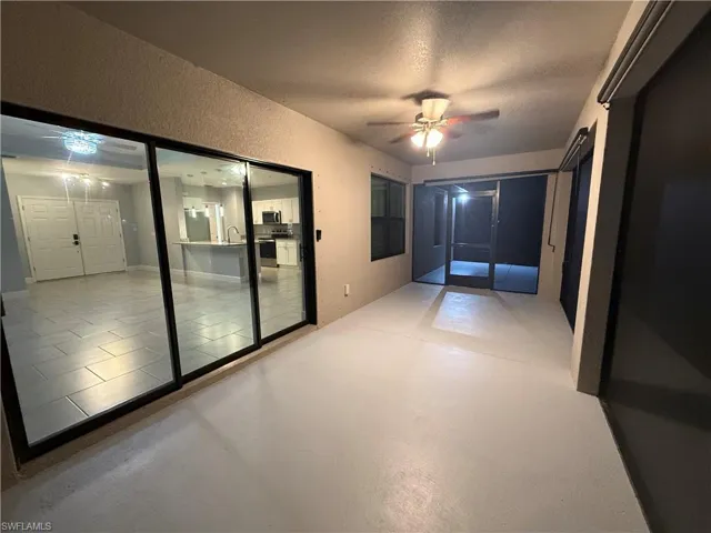 Unfurnished room with tile patterned floors, ceiling fan, sink, and a textured ceiling