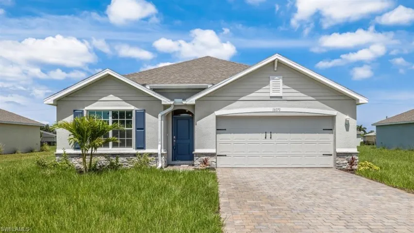 Model home. View of front of house featuring an attached garage, driveway, a front lawn, and a shingled roof