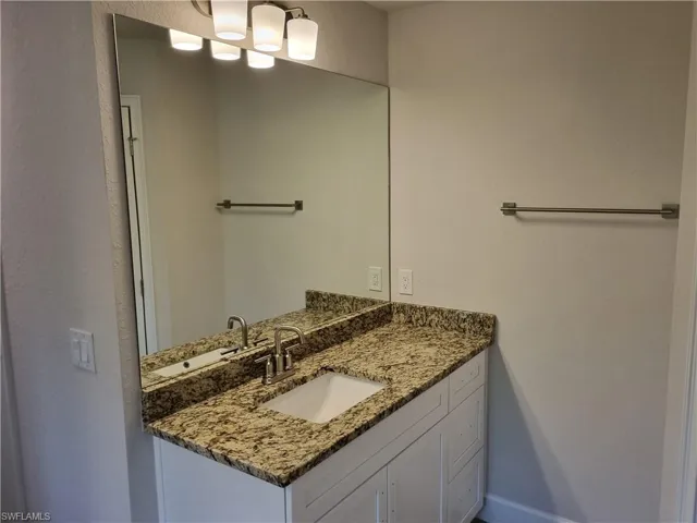 Bathroom featuring vanity and baseboards