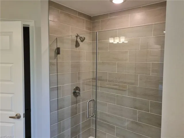 Full bathroom with a shower stall