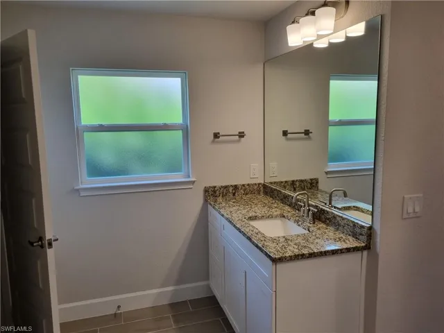 Bathroom with vanity and baseboards