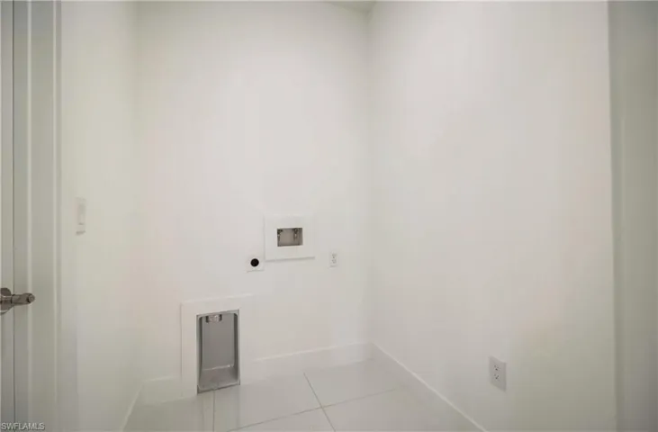 Clothes washing area featuring hookup for a washing machine, tile flooring, and electric dryer hookup