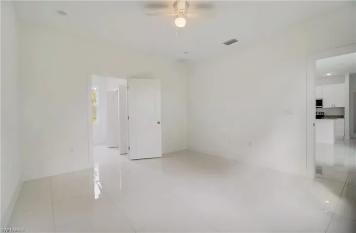 Spare room featuring ceiling fan and light tile flooring