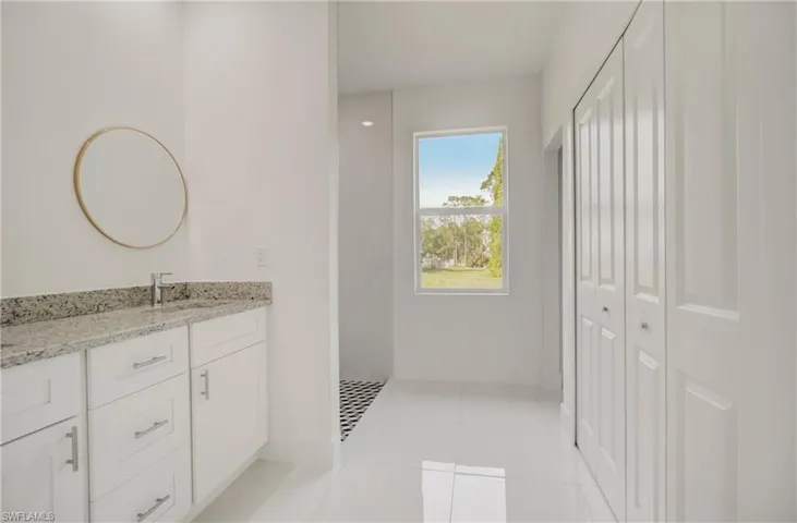 Bathroom with tile flooring and vanity