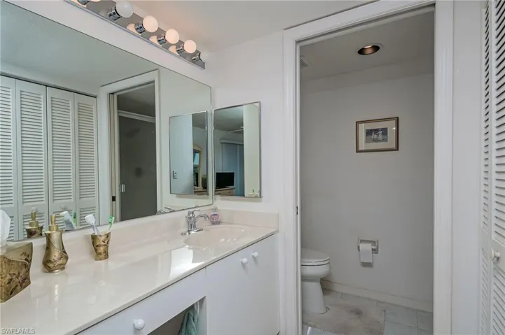 Bathroom with tile patterned flooring, vanity, and toilet