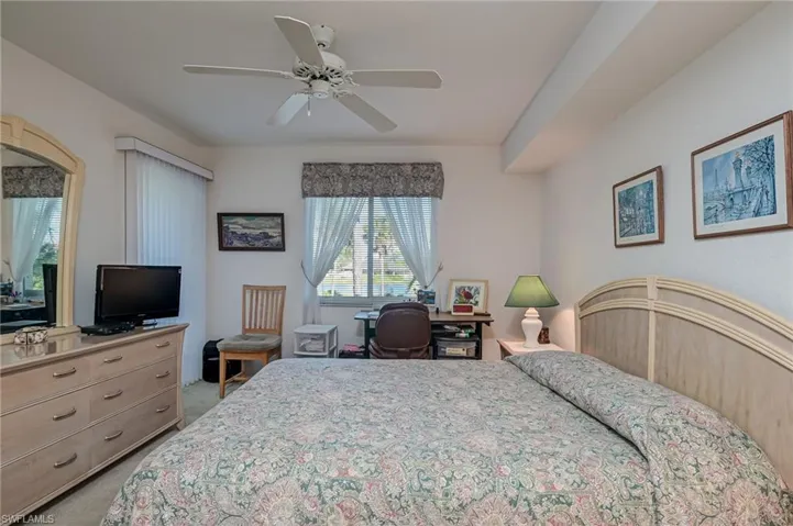 Carpeted bedroom with ceiling fan