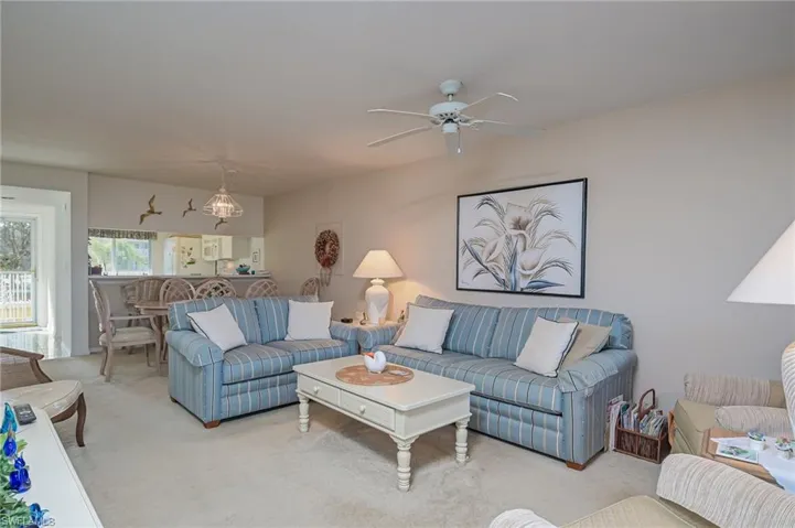 Living room featuring ceiling fan and light colored carpet