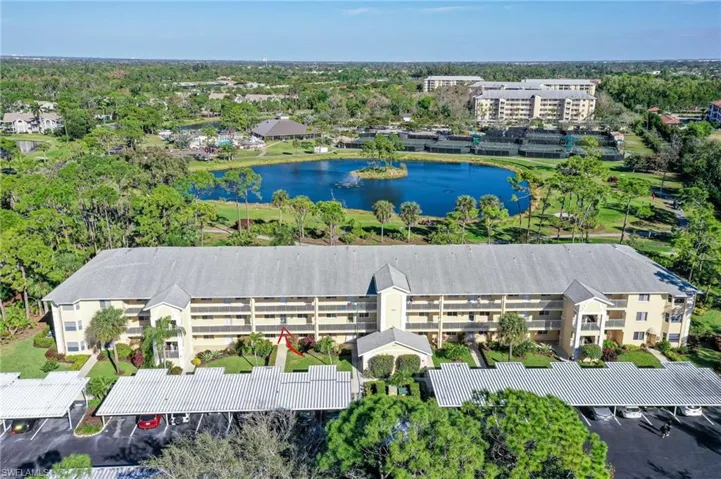 Birds eye view of property with a water view