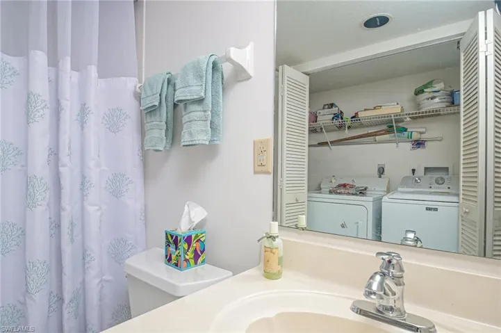 Bathroom featuring sink and washing machine and clothes dryer