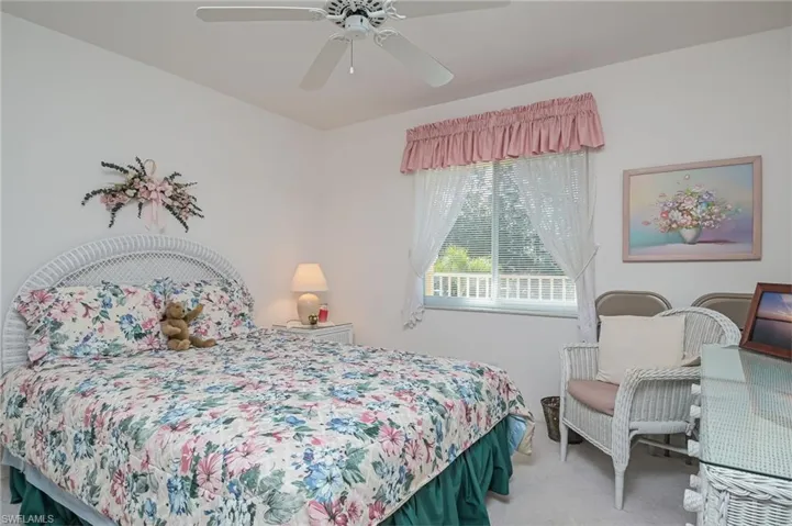 Bedroom featuring ceiling fan and carpet flooring