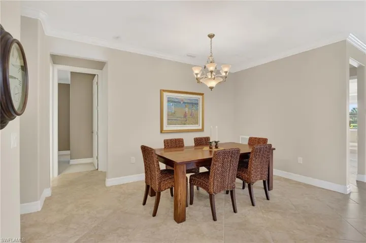 Dining area with a chandelier and ornamental molding