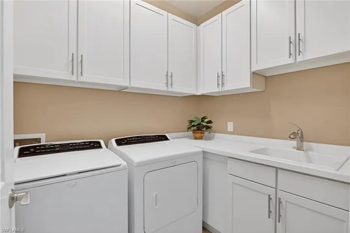 Laundry area with washer and clothes dryer and cabinet space