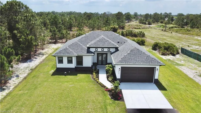 View of front of home with a garage and a front yard