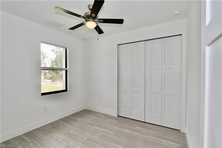 2nd bedroom featuring a closet and ceiling fan