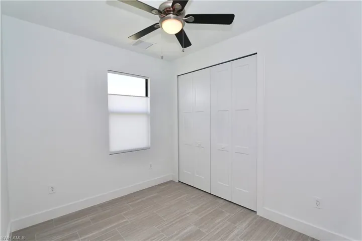 3rd bedroom featuring ceiling fan and a closet