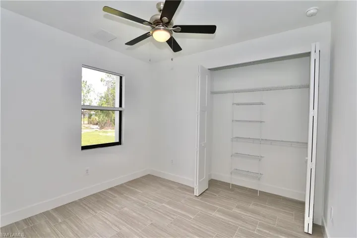 2nd bedroom with ceiling fan and a closet