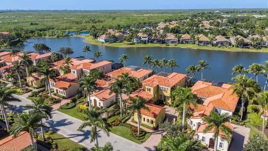 Aerial view of residential area featuring a nearby body of water