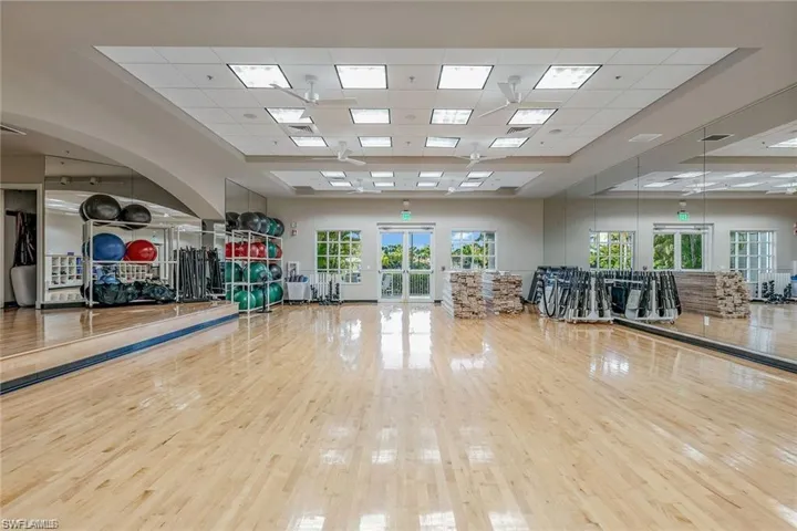 Workout room featuring a paneled ceiling and french doors