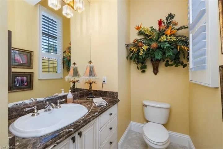 Bathroom featuring vanity and a chandelier