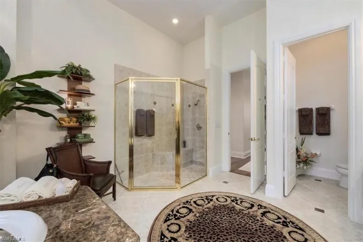 Bathroom with a shower stall, light tile patterned floors, and recessed lighting