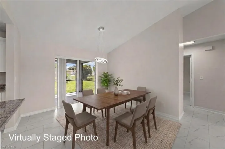 White tile flooring, modern suspended light fixture, and sliding glass door