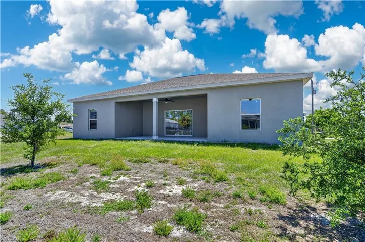 The property features a spacious rear yard with a covered patio, ideal for outdoor enjoyment