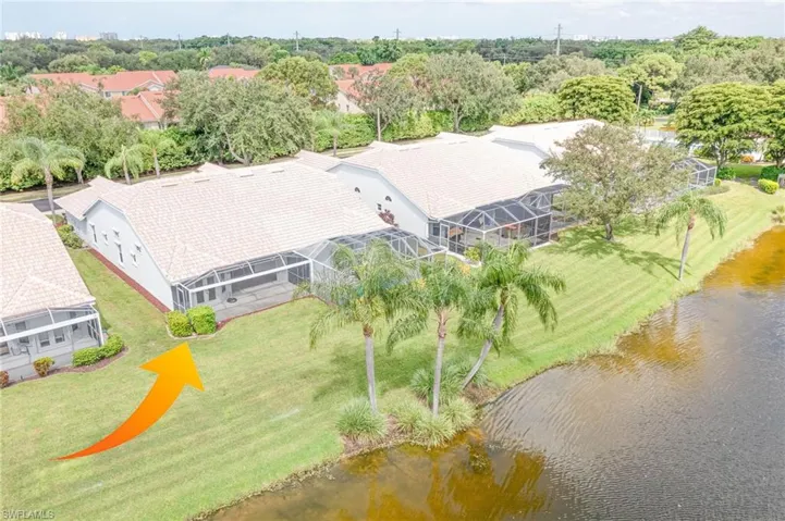 Birds eye view of property with a water view