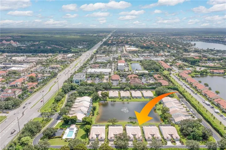 Birds eye view of property with a water view and a residential view