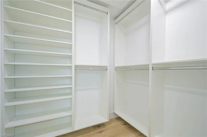 Spacious closet featuring light wood-style floors