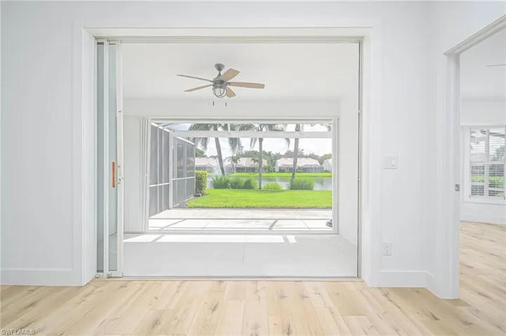 Entryway featuring ceiling fan, wood finished floors, and baseboards