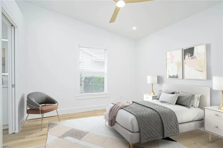 Virtually Staged Bedroom featuring light wood-style flooring, ceiling fan, baseboards, and vaulted ceiling
