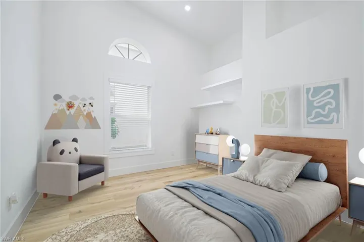 Virtually Staged Bedroom with high vaulted ceiling, baseboards, and wood finished floors