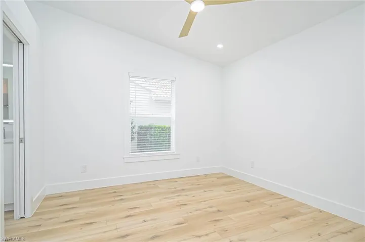 Spare room with baseboards, vaulted ceiling, recessed lighting, ceiling fan, and light wood finished floors