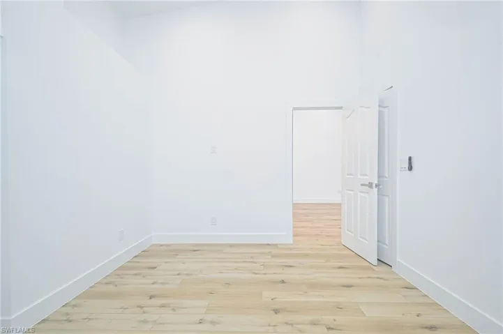 Spare room with light wood-style floors and baseboards