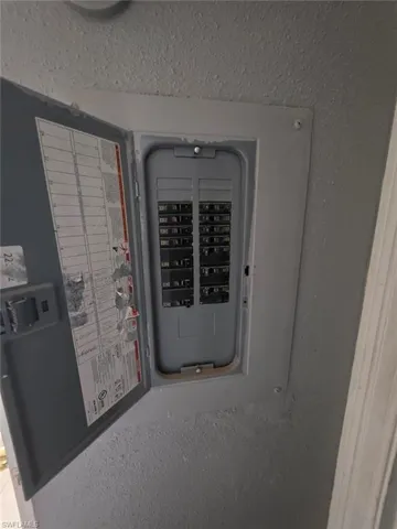 Electrical panel with an open door revealing multiple circuit breakers