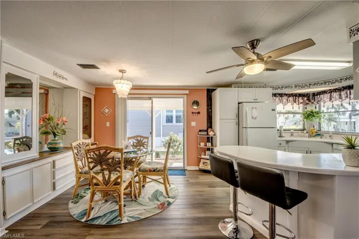 Dining space with visible vents, a ceiling fan, and dark wood finished floors