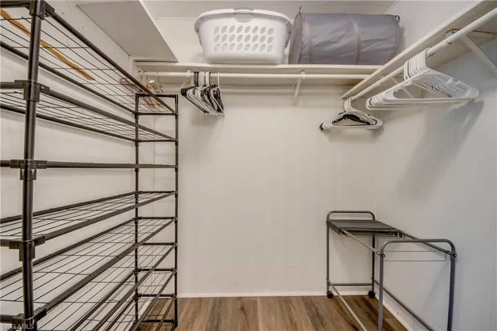 Walk in closet featuring wood finished floors