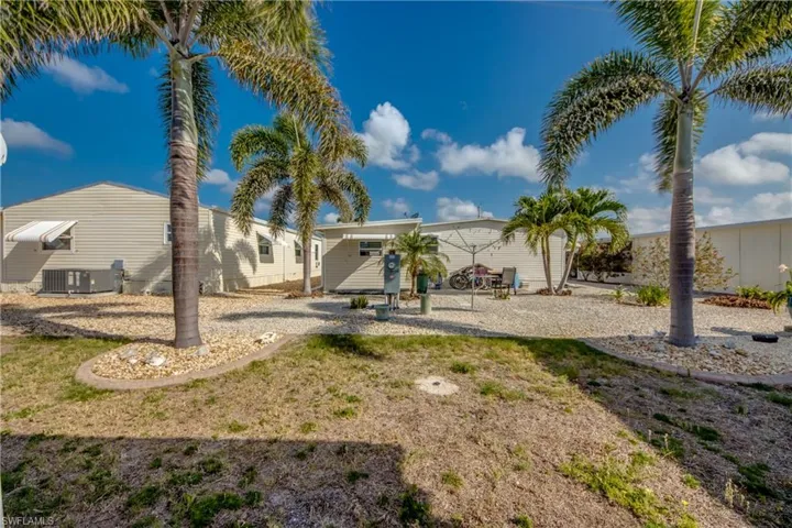 Rear view of property featuring central AC