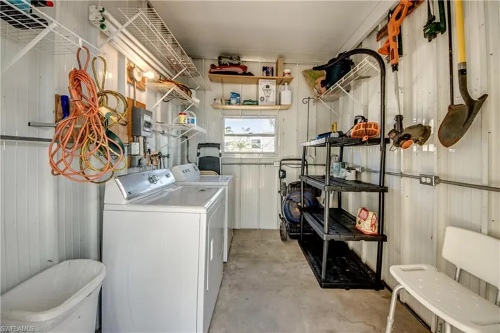 Washroom featuring separate washer and dryer and laundry area