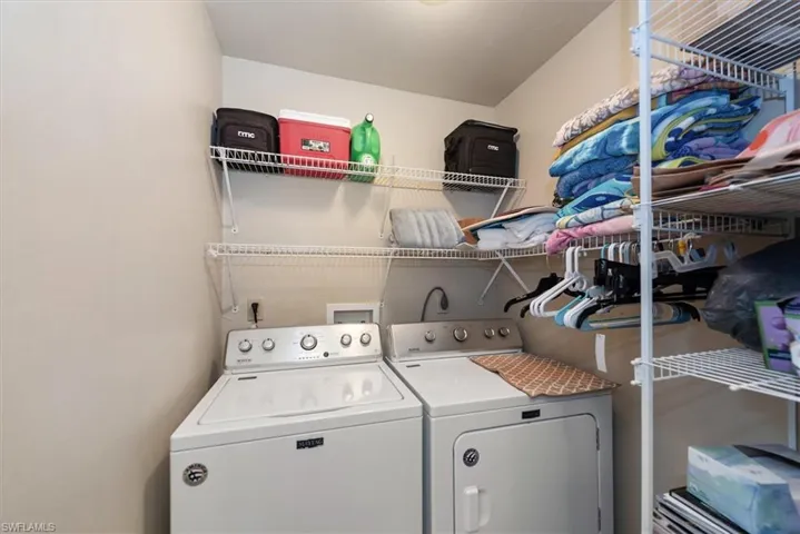 Washroom featuring washing machine and dryer