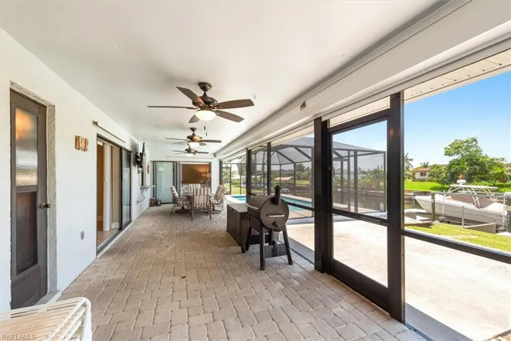 Sunroom featuring a ceiling fan