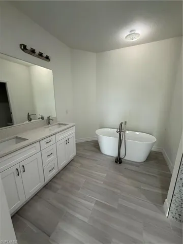 Full bath with a freestanding tub and double vanity