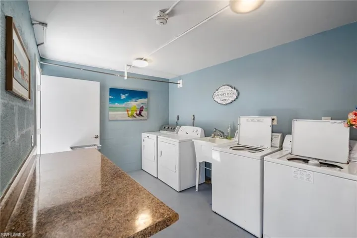 Shared laundry room with washing machine and dryer